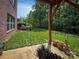 Backyard featuring a covered patio, a well-manicured lawn, and the perimeter is bordered by trees at 4006 Tremont Dr, Indian Trail, NC 28079