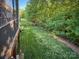 Expansive backyard with a well-manicured lawn, mature trees, and a peaceful ambiance, perfect for relaxation at 4006 Tremont Dr, Indian Trail, NC 28079