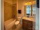 Well-lit bathroom featuring tile floors, a tub-shower combination, and granite vanity at 4006 Tremont Dr, Indian Trail, NC 28079
