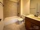 Bathroom has a tiled shower and bathtub, toilet and vanity sink at 4006 Tremont Dr, Indian Trail, NC 28079