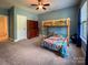 Bright bedroom featuring a unique bunk bed, ceiling fan, and ample natural light at 4006 Tremont Dr, Indian Trail, NC 28079