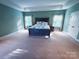 Generous bedroom with tray ceiling, windows and carpeted floor at 4006 Tremont Dr, Indian Trail, NC 28079