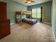 Bedroom with a bunk bed, carpeted floor, ceiling fan and a window providing ample light at 4006 Tremont Dr, Indian Trail, NC 28079