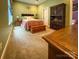 Comfortable bedroom featuring carpet, a bed with decorative pillows, and a wooden chest, exuding warmth at 4006 Tremont Dr, Indian Trail, NC 28079