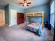 Charming bedroom features a bunk bed, wooden dresser, and blue walls with a window at 4006 Tremont Dr, Indian Trail, NC 28079