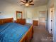 Spacious bedroom featuring a ceiling fan, closet and wooden furniture, creating a cozy atmosphere at 4006 Tremont Dr, Indian Trail, NC 28079