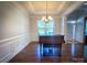 Elegant dining room with hardwood floors, classic chandelier, and views of the landscaped yard at 4006 Tremont Dr, Indian Trail, NC 28079