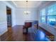 Formal dining room showcasing a tray ceiling, hardwood floors, and large windows for ample natural light at 4006 Tremont Dr, Indian Trail, NC 28079