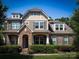 Charming two-story home with a brick and stone facade, complemented by lush greenery and professional landscaping at 4006 Tremont Dr, Indian Trail, NC 28079