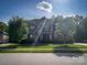 Two story house with stone facade and landscaped front yard on a sunny day at 4006 Tremont Dr, Indian Trail, NC 28079