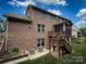 Brick home's backyard with deck and patio, showcasing outdoor living spaces at 4006 Tremont Dr, Indian Trail, NC 28079