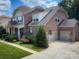 Beautiful brick home with a two-car garage, well-maintained lawn, and lush landscaping at 4006 Tremont Dr, Indian Trail, NC 28079
