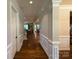 Elegant hallway featuring hardwood floors, detailed trim, and views into multiple living spaces at 4006 Tremont Dr, Indian Trail, NC 28079