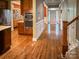 Hallway with hardwood floors, decorative wainscoting, and access to the kitchen and front door at 4006 Tremont Dr, Indian Trail, NC 28079