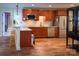Kitchen featuring wooden cabinets, granite countertops, stainless steel appliances, and hardwood floors at 4006 Tremont Dr, Indian Trail, NC 28079