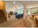 Open living room with a staircase, fireplace, large windows, and hardwood floors at 4006 Tremont Dr, Indian Trail, NC 28079