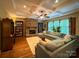 Inviting living room featuring stone fireplace, built-in bookshelves, and coffered ceilings at 4006 Tremont Dr, Indian Trail, NC 28079