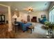 Spacious living room with plush carpeting, a ceiling fan, and comfortable seating, creating an inviting atmosphere at 4006 Tremont Dr, Indian Trail, NC 28079