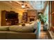 Comfortable living room boasts a stone fireplace, built-in bookshelves, and hardwood floors at 4006 Tremont Dr, Indian Trail, NC 28079