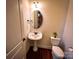 Charming powder room with pedestal sink, oval mirror, and modern toilet at 4006 Tremont Dr, Indian Trail, NC 28079