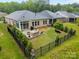 Aerial view of a fenced backyard with a cozy patio area for outdoor enjoyment at 4008 Leyland Ct, Mint Hill, NC 28227