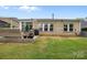 Exterior home view featuring patio and lush green backyard at 4008 Leyland Ct, Mint Hill, NC 28227