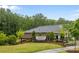 Entrance to Heron Creek community with lush green landscape and stone monument at 4008 Leyland Ct, Mint Hill, NC 28227