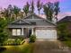 Charming home featuring stone accents, a two-car garage, and well-maintained landscaping at 4008 Leyland Ct, Mint Hill, NC 28227