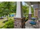 Inviting front porch with stone columns and outdoor seating area at 4008 Leyland Ct, Mint Hill, NC 28227