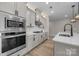Modern kitchen with stainless steel appliances, white cabinets, and quartz countertops at 4008 Leyland Ct, Mint Hill, NC 28227