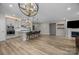 Open-concept living area with island seating, fireplace, and modern lighting fixtures at 4008 Leyland Ct, Mint Hill, NC 28227