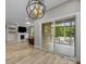 Spacious living room featuring hardwood floors, fireplace, and a sunroom at 4008 Leyland Ct, Mint Hill, NC 28227