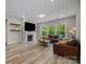 Spacious living room with fireplace, hardwood floors, and ample natural light at 4008 Leyland Ct, Mint Hill, NC 28227