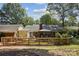 A beautiful backyard featuring a patio, pergola, and a wooden fence, all nestled in a lush green setting at 405 Scarborough Ln, Matthews, NC 28105
