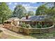Spacious backyard featuring a patio, pergola, brick accents, and a wooden fence, nestled in a lush landscape at 405 Scarborough Ln, Matthews, NC 28105