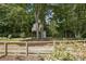 Spacious backyard featuring a custom-built treehouse and shed, surrounded by lush trees at 405 Scarborough Ln, Matthews, NC 28105