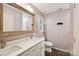 Bright bathroom with a double vanity, stylish mirror, and wood look flooring at 405 Scarborough Ln, Matthews, NC 28105
