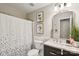 Well-lit bathroom featuring a vanity with marbled counter and white fixtures at 405 Scarborough Ln, Matthews, NC 28105