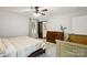 Bedroom featuring a ceiling fan, natural light, and a view of the ensuite bathroom at 405 Scarborough Ln, Matthews, NC 28105
