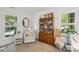 Light-filled Bedroom with comfortable glider, bookcase, and charming decor at 405 Scarborough Ln, Matthews, NC 28105