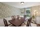 Bright dining room with hardwood floors, wallpaper and large window for natural light at 405 Scarborough Ln, Matthews, NC 28105