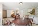An inviting dining room with wooden table, chairs, and accent wall with floral wallpaper and decorative painting at 405 Scarborough Ln, Matthews, NC 28105