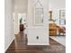 Hallway featuring hardwood floors with a piano to the right and view of the living room in the back at 405 Scarborough Ln, Matthews, NC 28105