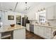 Bright kitchen with white cabinets, granite countertops, and stainless steel appliances, with laundry room in view at 405 Scarborough Ln, Matthews, NC 28105