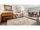 Bright living room with hardwood floors, vintage rug, piano and open access to the dining room at 405 Scarborough Ln, Matthews, NC 28105