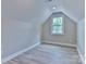 Cozy bedroom with neutral walls, wood-look flooring, and natural light from the window at 418 Harrison St, Statesville, NC 28677