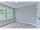 Bright bedroom features two windows, wood-look flooring, and soft neutral walls at 418 Harrison St, Statesville, NC 28677