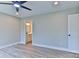 Neutral bedroom with light walls, ceiling fan, and wood-look flooring, leading to an ensuite bath at 418 Harrison St, Statesville, NC 28677