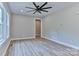 Spacious bedroom featuring light walls, wood-look floors, a modern ceiling fan, and natural light at 418 Harrison St, Statesville, NC 28677