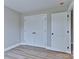 Bedroom with a double door closet and modern gray walls and flooring at 418 Harrison St, Statesville, NC 28677